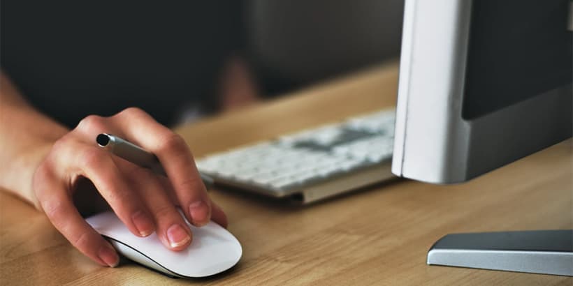 Woman’s hand holding a computer mouse